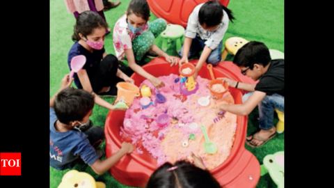Children exploring a water play table, from the Times of India report