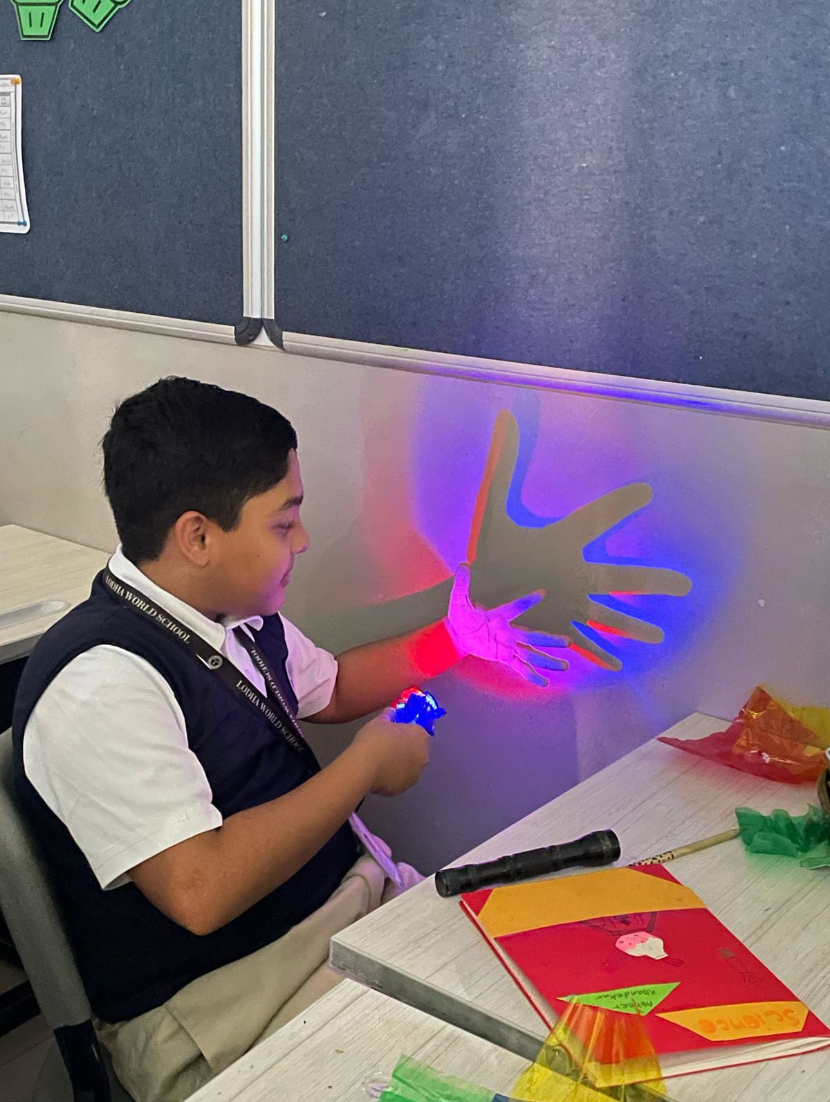 A boy exploring light and shadow at a hands-on station