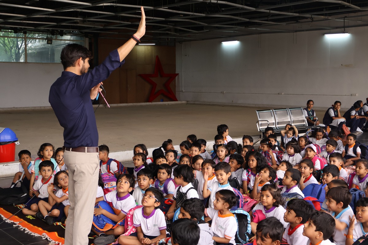 An S2S facilitator holding a whole-school session in a school hall